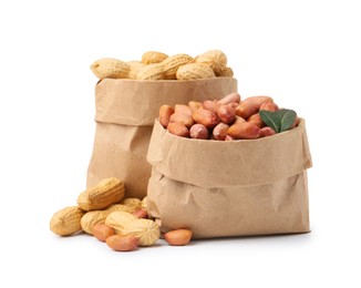Photo of Fresh peanuts in paper bags isolated on white