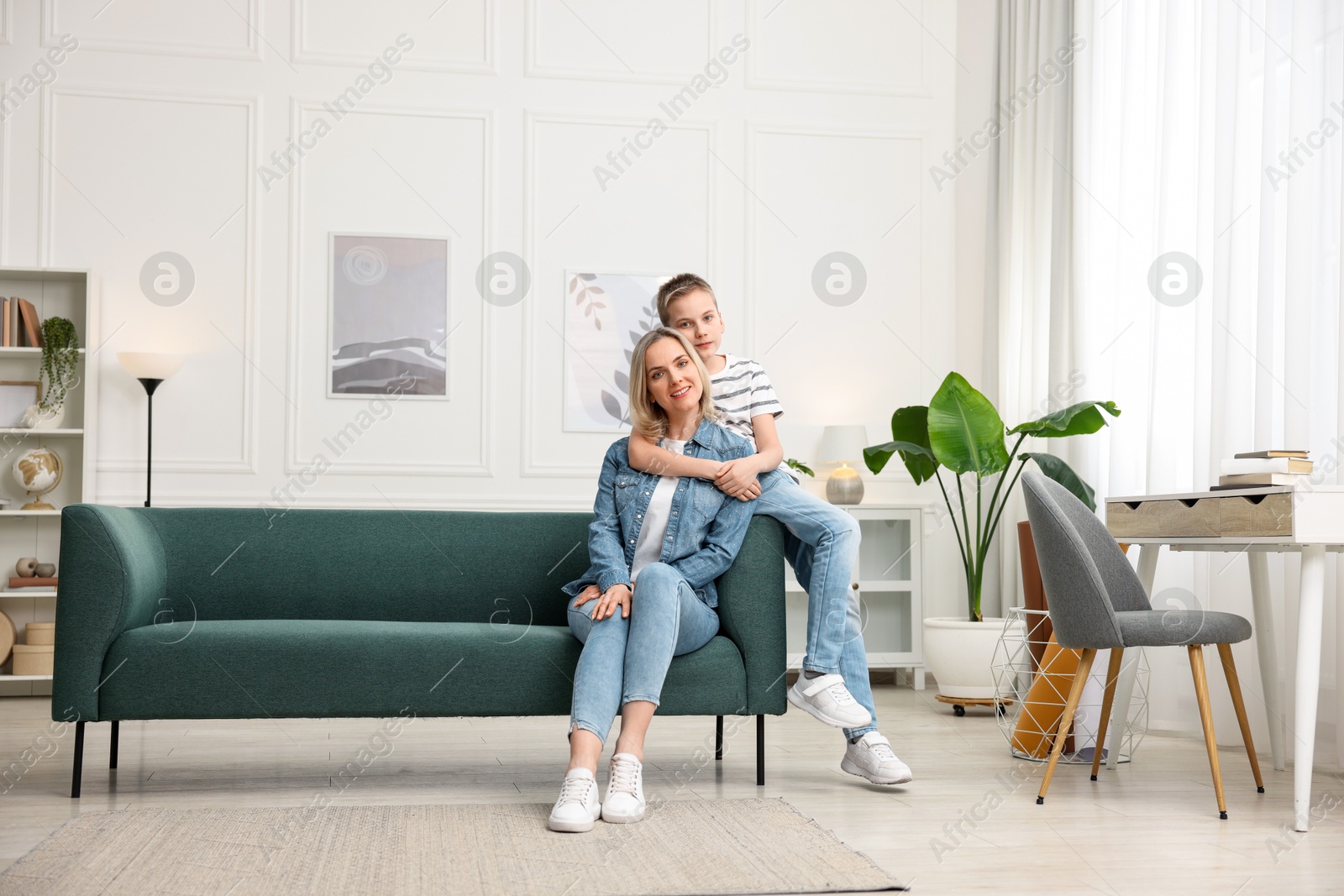 Photo of Mother and son on sofa at home