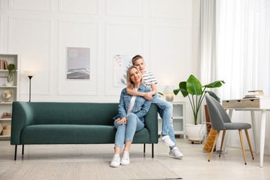 Photo of Mother and son on sofa at home