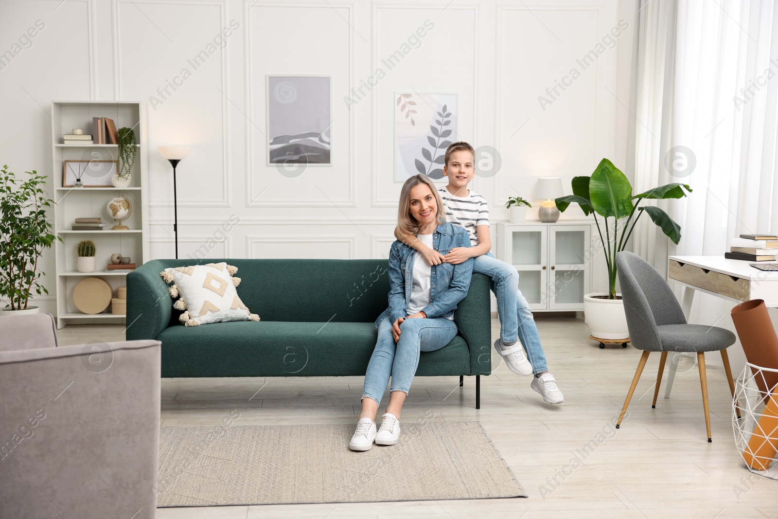 Photo of Mother and son on sofa at home