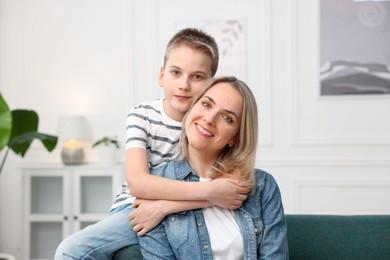 Photo of Mother and son on sofa at home