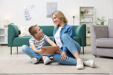 Photo of Mother and son with tablet at home