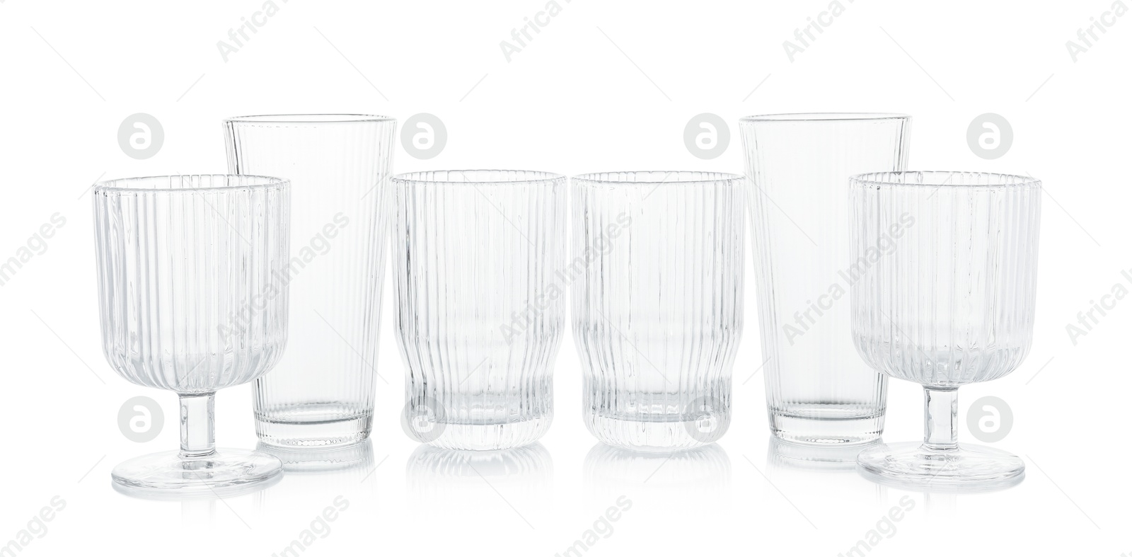 Photo of Many empty clean glasses isolated on white