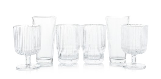 Photo of Many empty clean glasses isolated on white