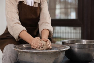 Photo of Hobby and craft. Woman making pottery indoors, closeup