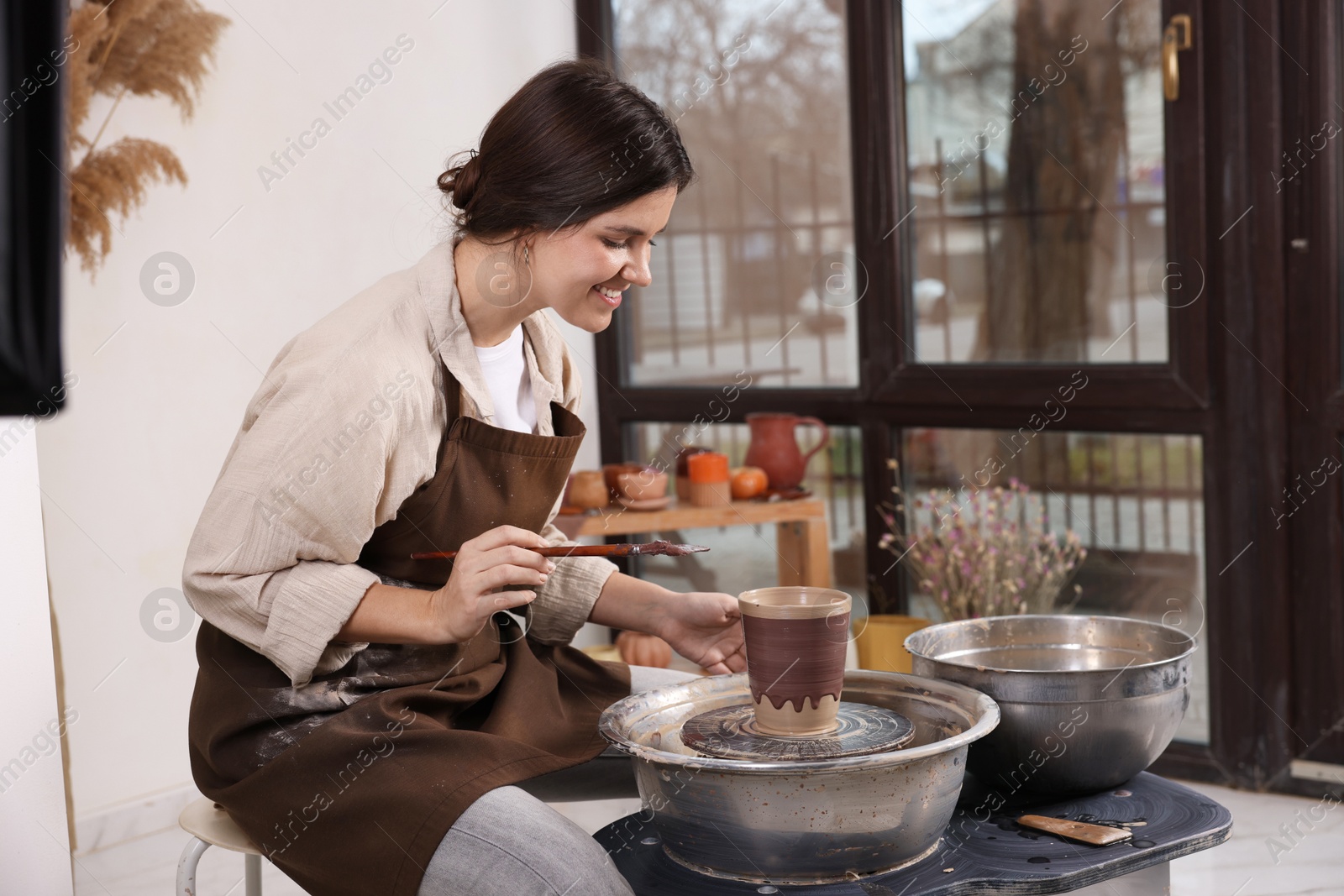 Photo of Hobby and craft. Smiling woman making pottery indoors