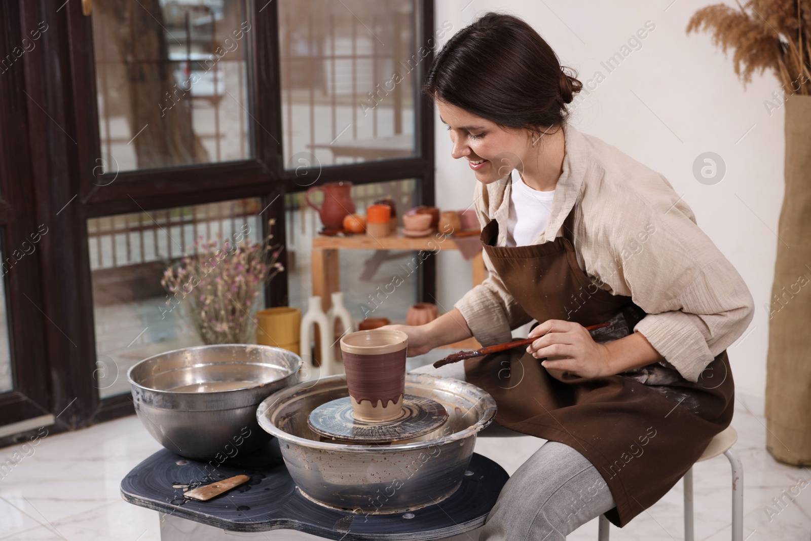 Photo of Hobby and craft. Smiling woman making pottery indoors