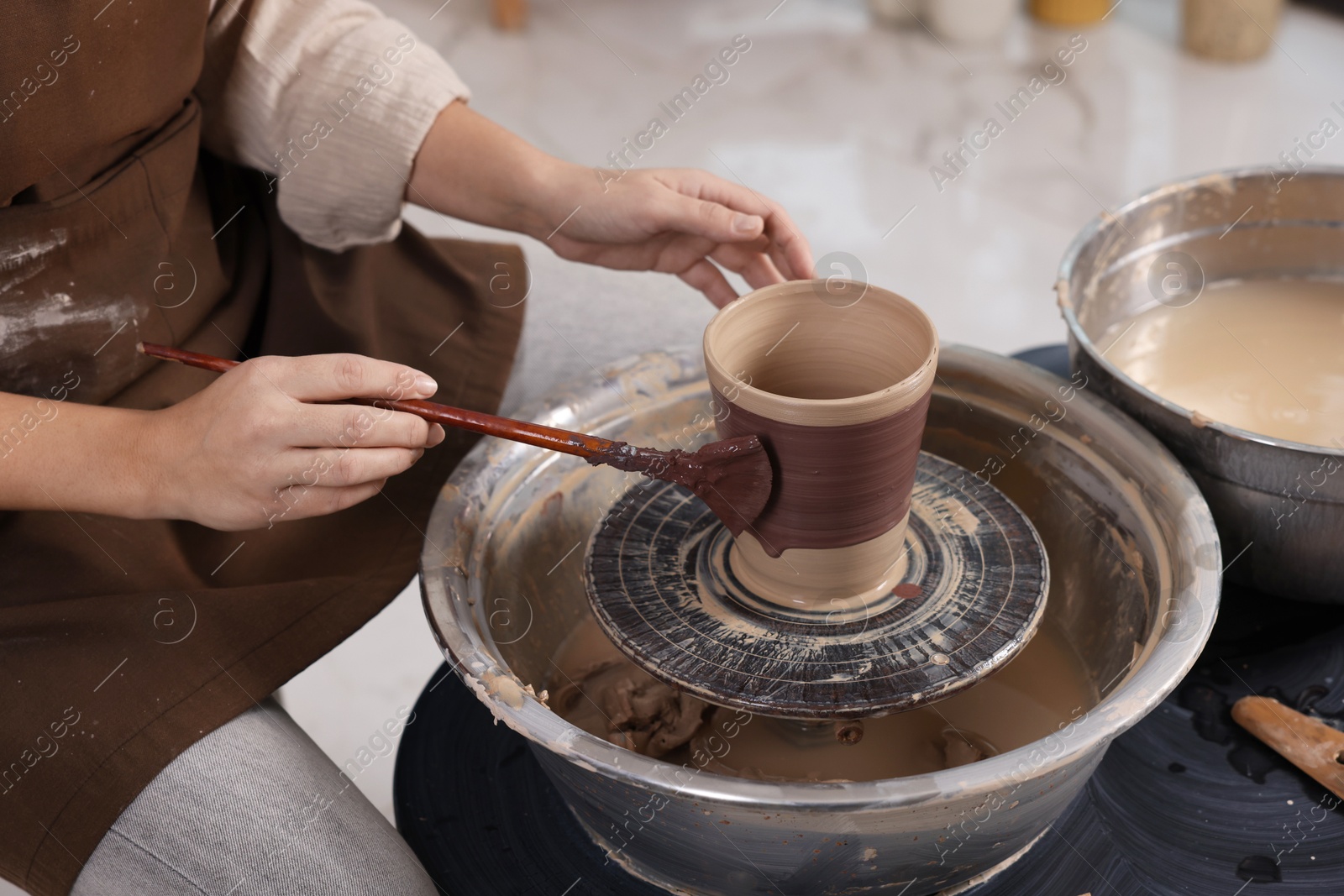 Photo of Hobby and craft. Woman making pottery indoors, closeup