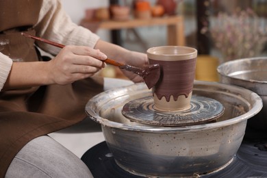 Photo of Hobby and craft. Woman making pottery indoors, closeup