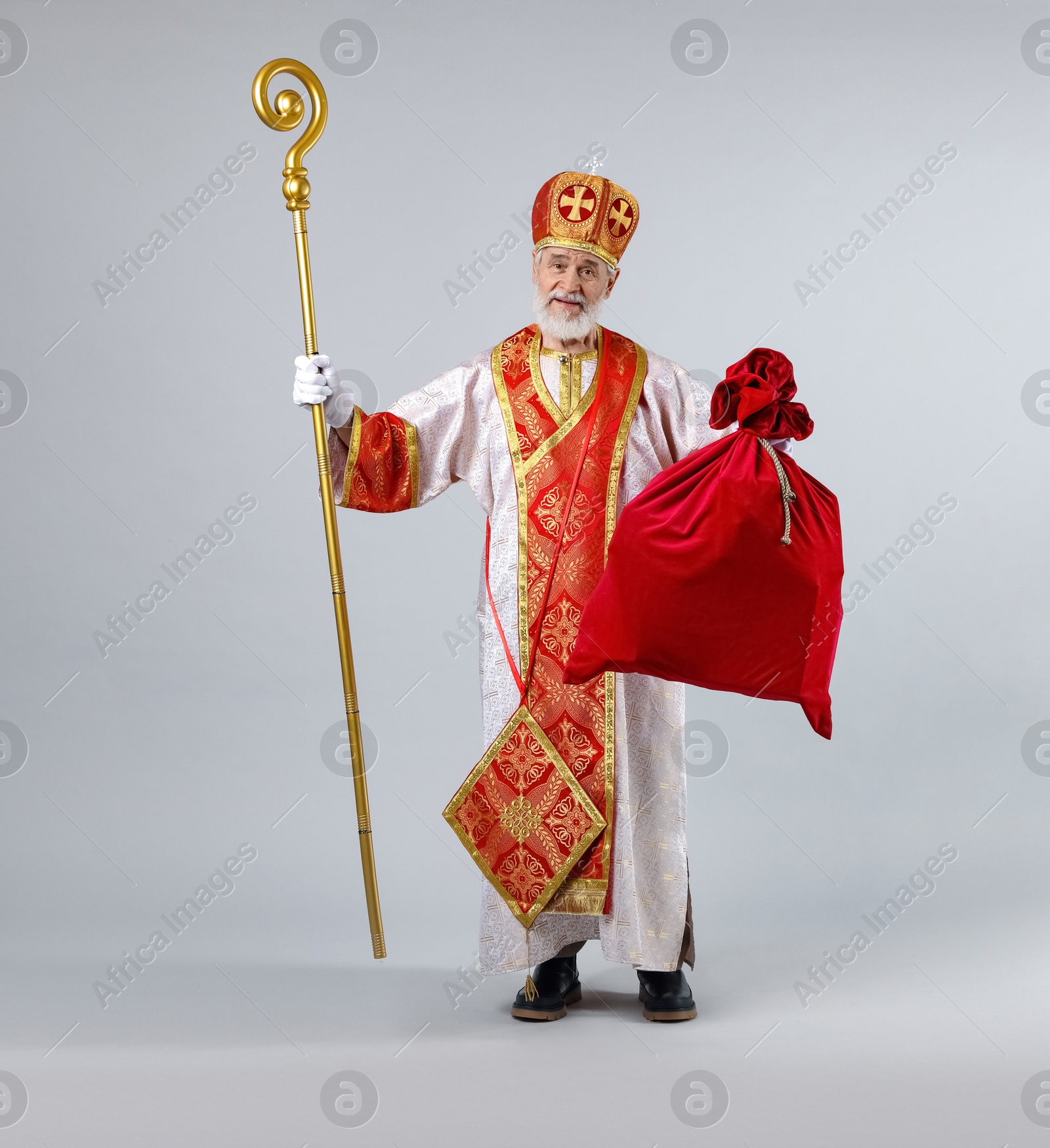 Photo of Saint Nicholas with sack on light grey background