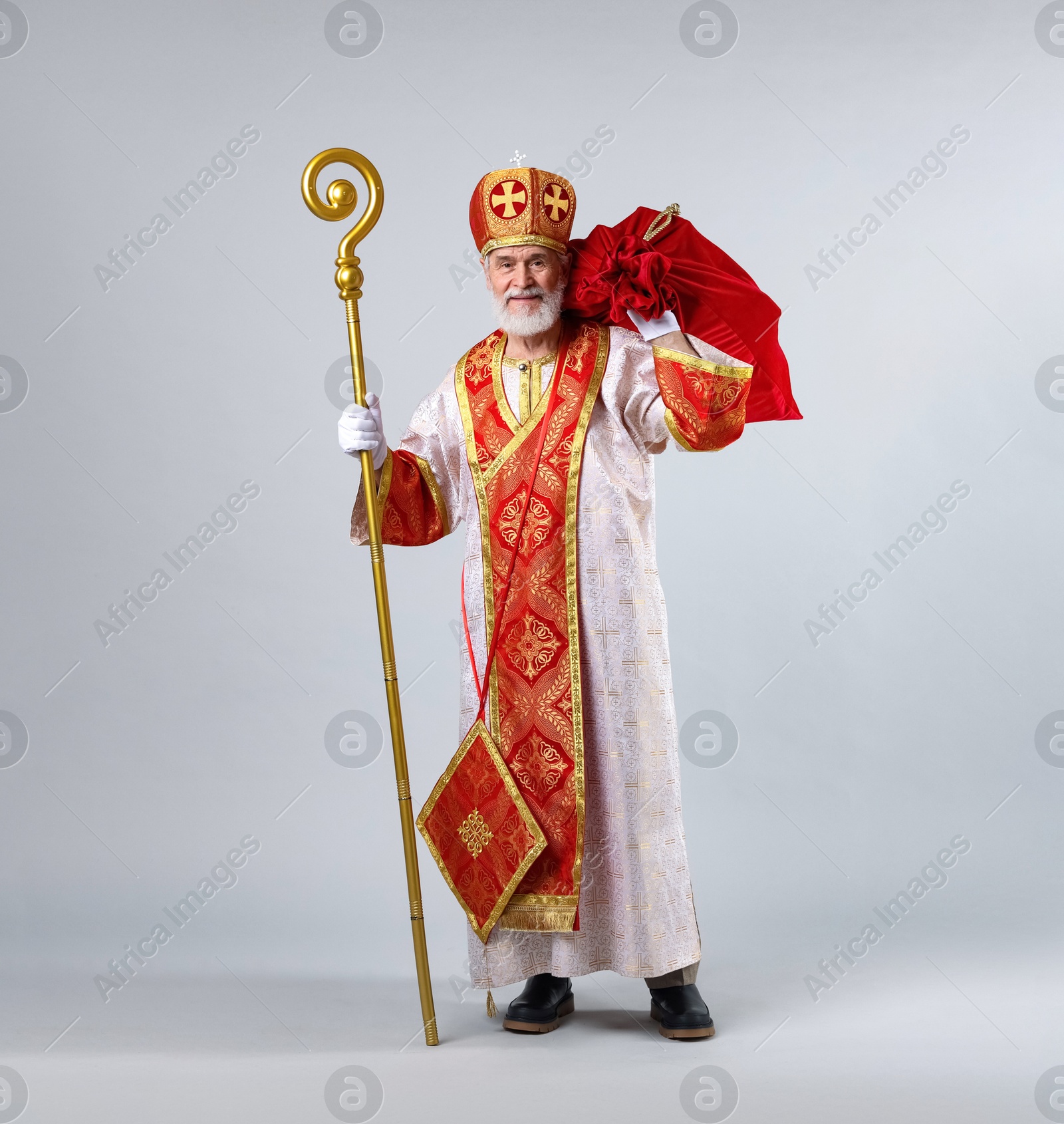 Photo of Saint Nicholas with sack on light grey background