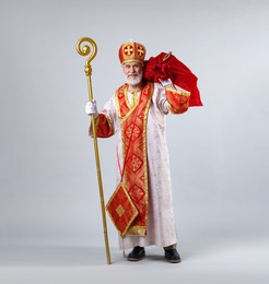 Photo of Saint Nicholas with sack on light grey background