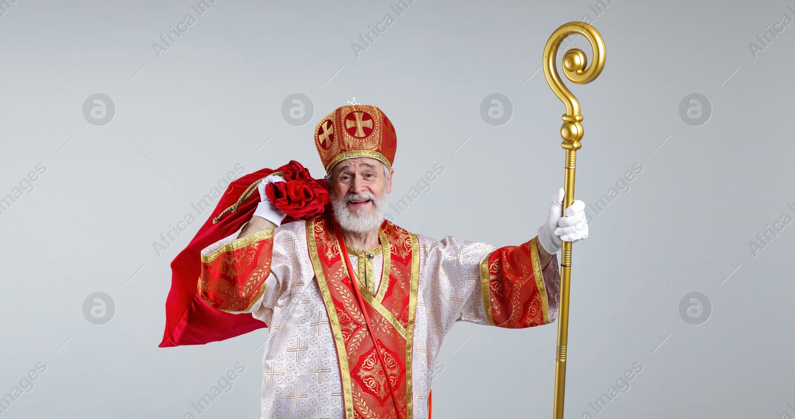 Photo of Saint Nicholas with sack on light grey background