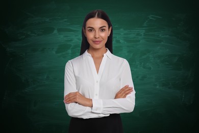 Portrait of woman near green chalkboard. Teacher, business coach