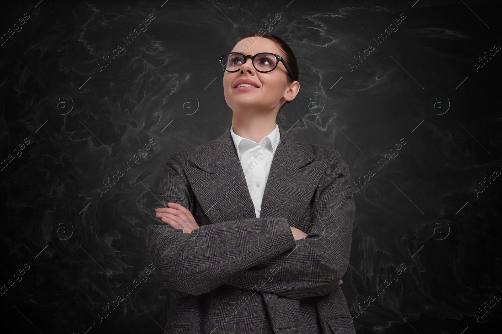 Image of Portrait of woman near black chalkboard. Teacher, business coach