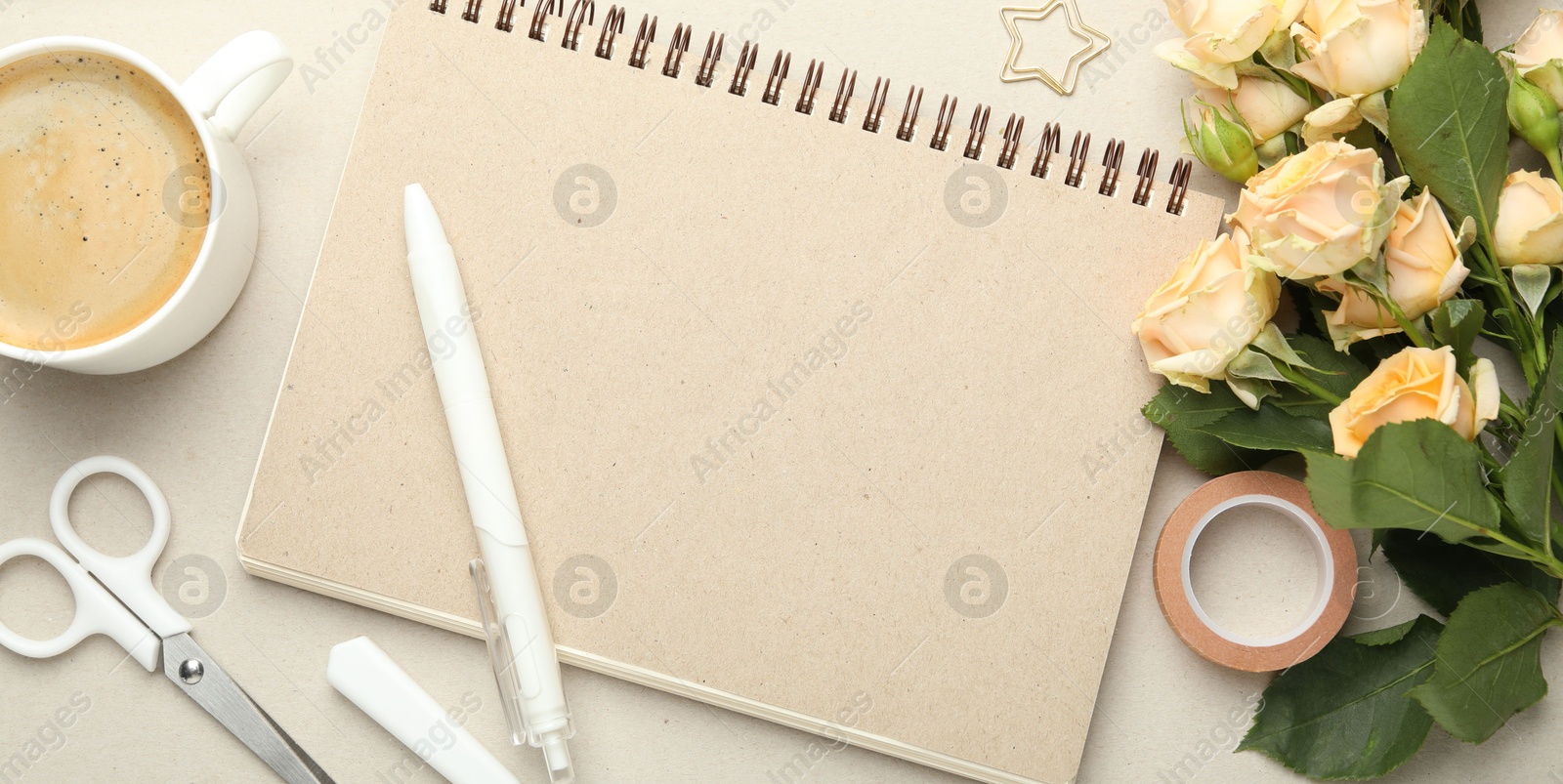 Photo of Paper clip, other stationery, coffee and roses on light grey background, flat lay