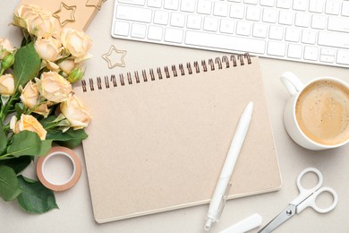 Paper clips, other stationery, coffee, computer keyboard and roses on light grey background, flat lay