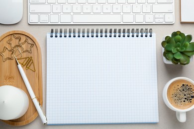 Paper clips, other stationery, coffee, decor and computer keyboard on light grey background, flat lay