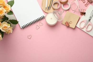 Photo of Paper clips, other stationery and decor on pink background, flat lay. Space for text