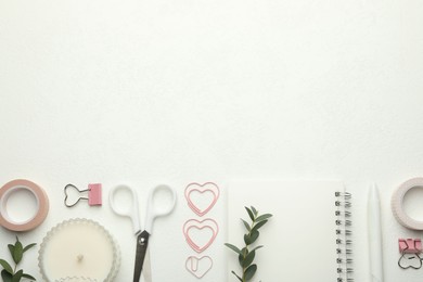 Photo of Paper clips, other stationery and green branches on white background, flat lay. Space for text