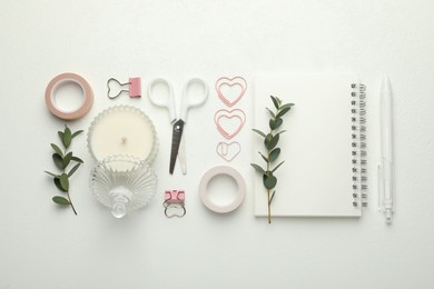 Photo of Paper clips, other stationery and green branches on white background, flat lay