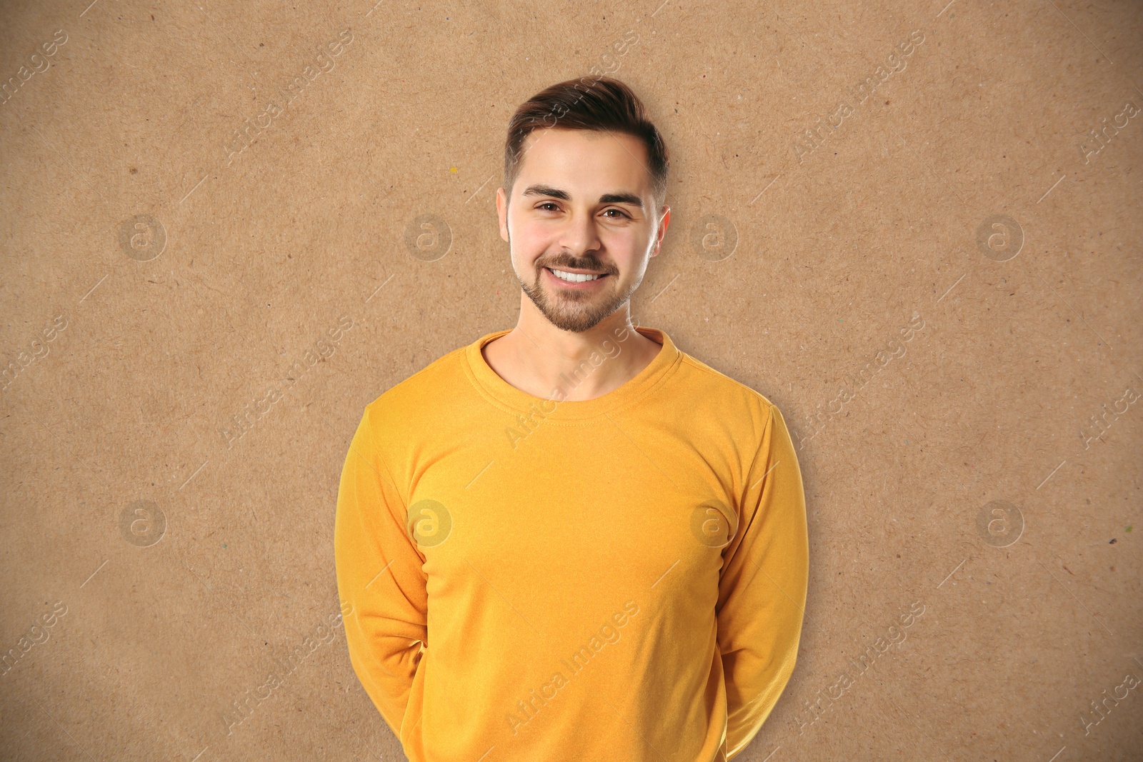 Image of Portrait of handsome man posing against kraft paper