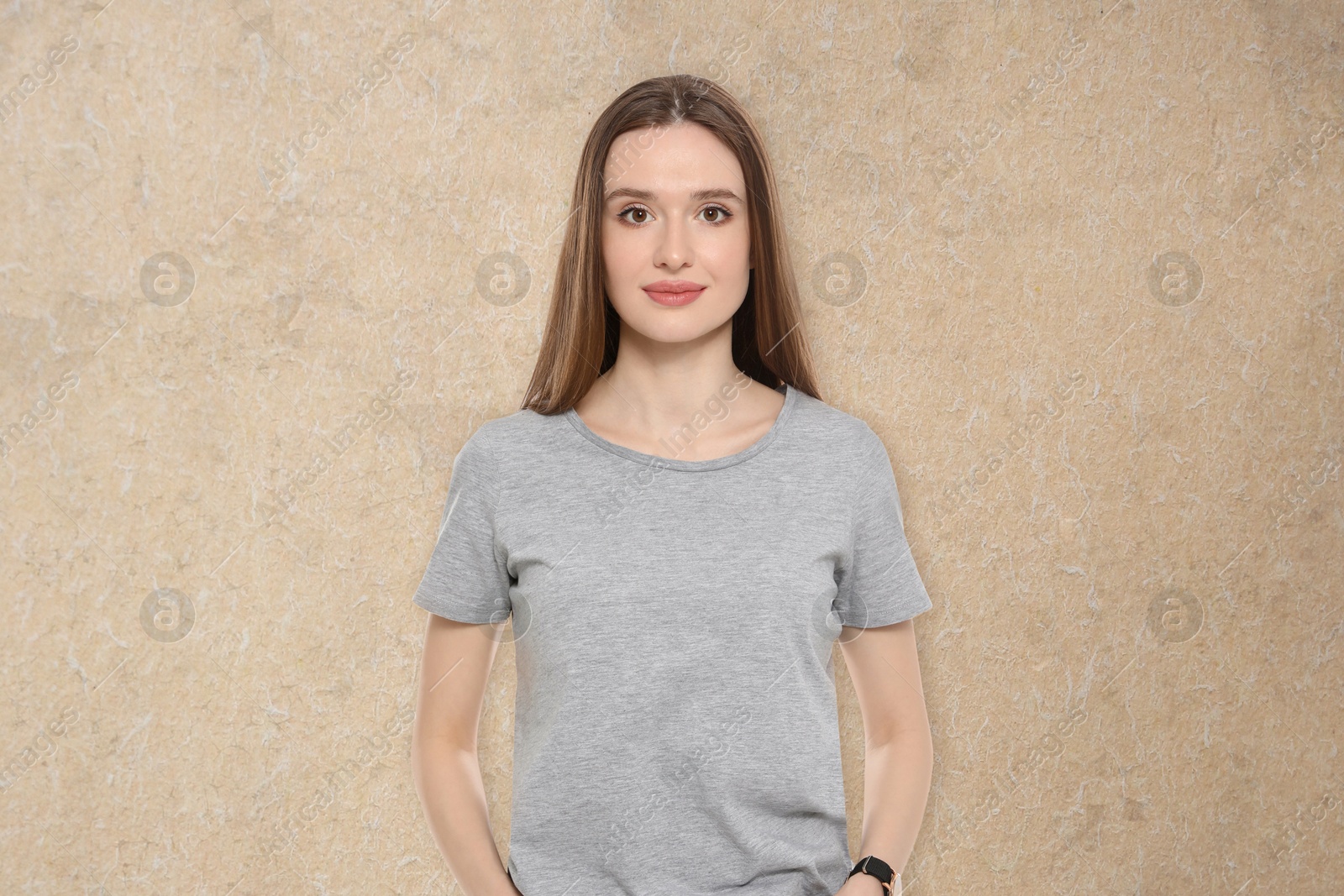 Image of Portrait of beautiful young woman on beige textured background