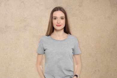 Image of Portrait of beautiful young woman on beige textured background