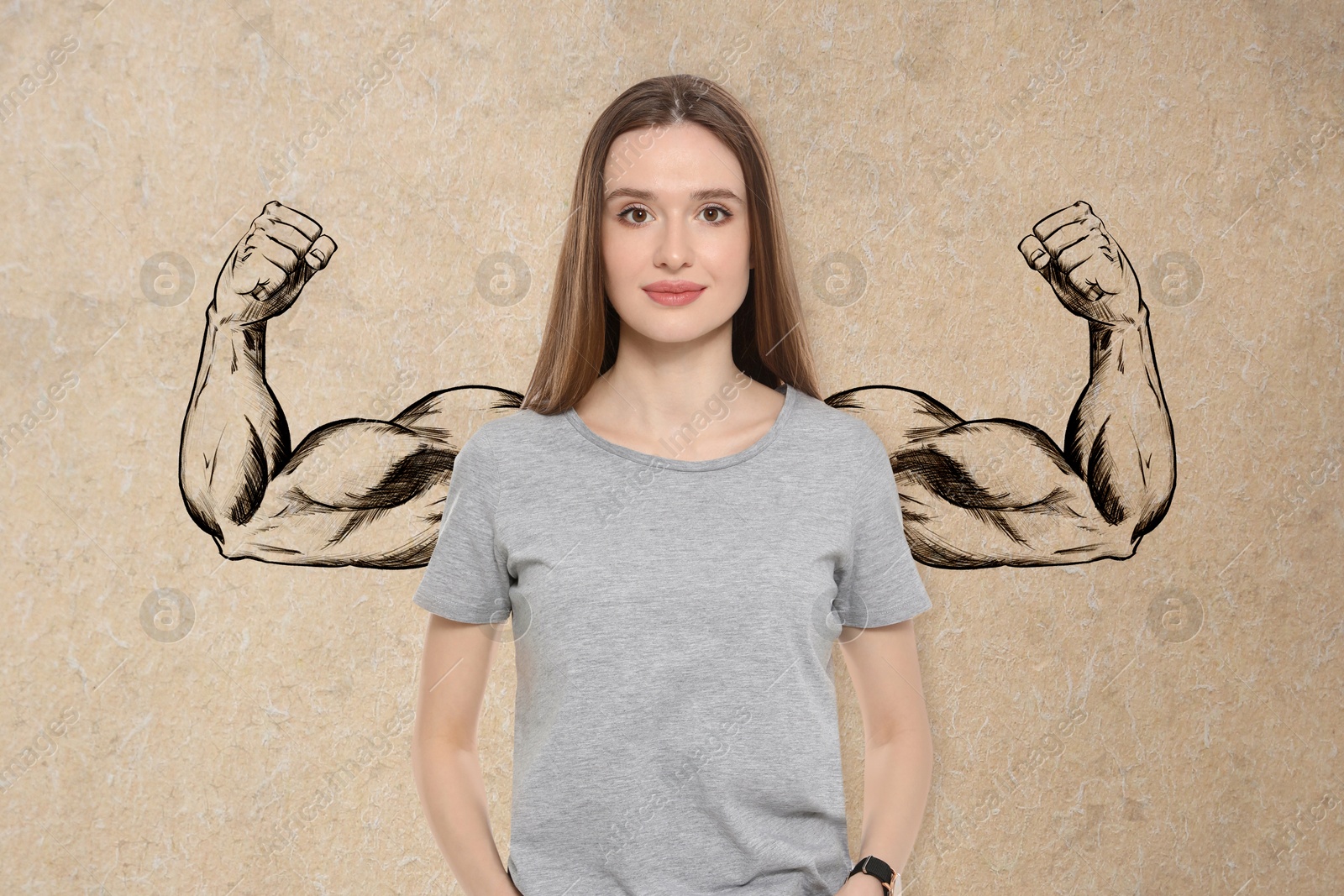 Image of Confident woman with drawing of strong arms behind her on beige background