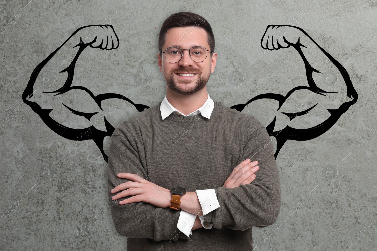 Image of Confident man with drawing of strong arms behind him on grey background