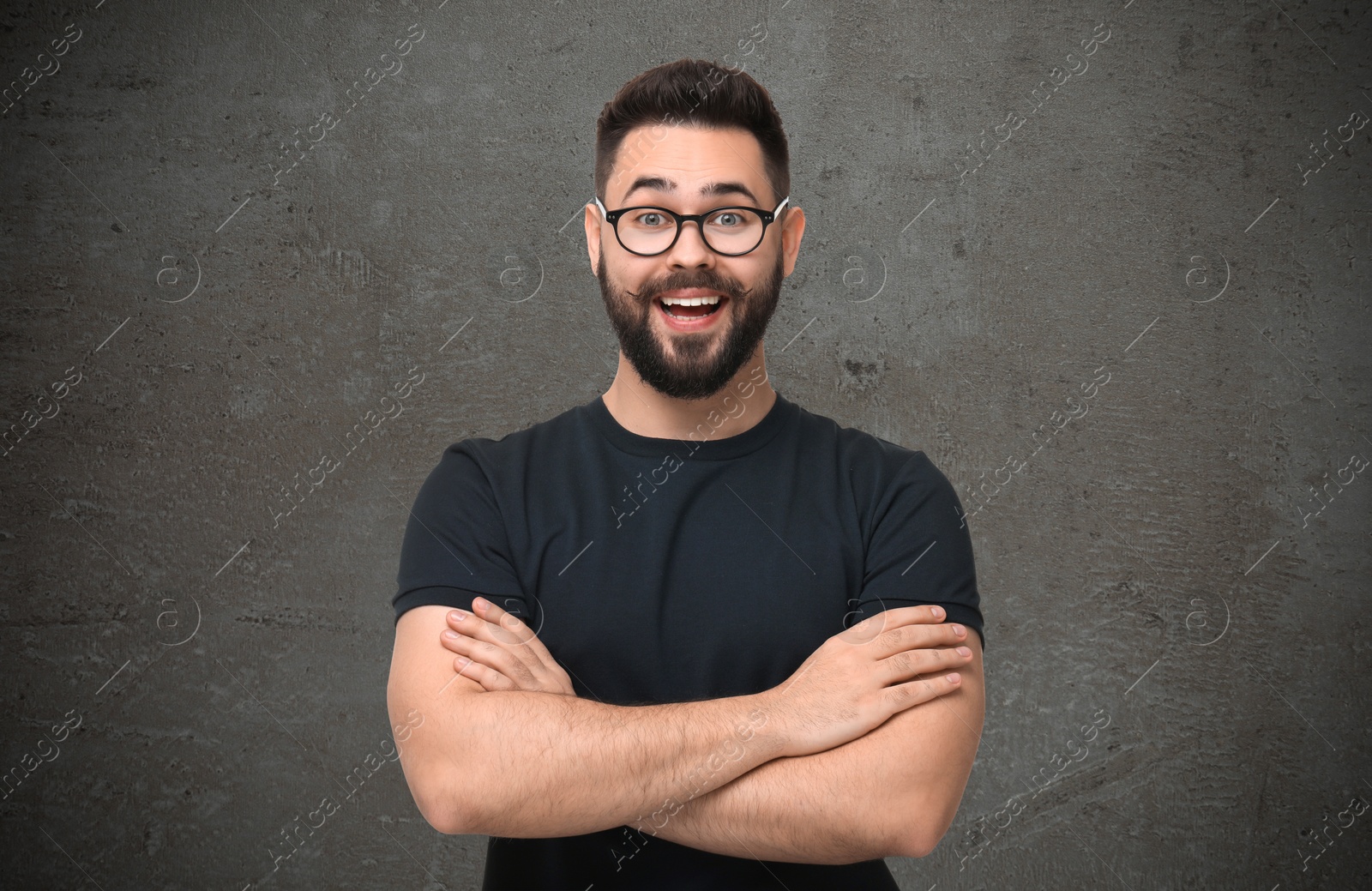 Image of Portrait of happy young man on grey textured background