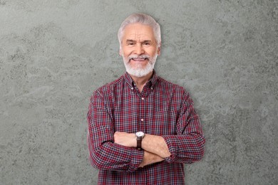 Image of Portrait of happy senior man on grey textured background