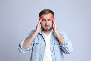 Image of Man suffering from headache on grey background