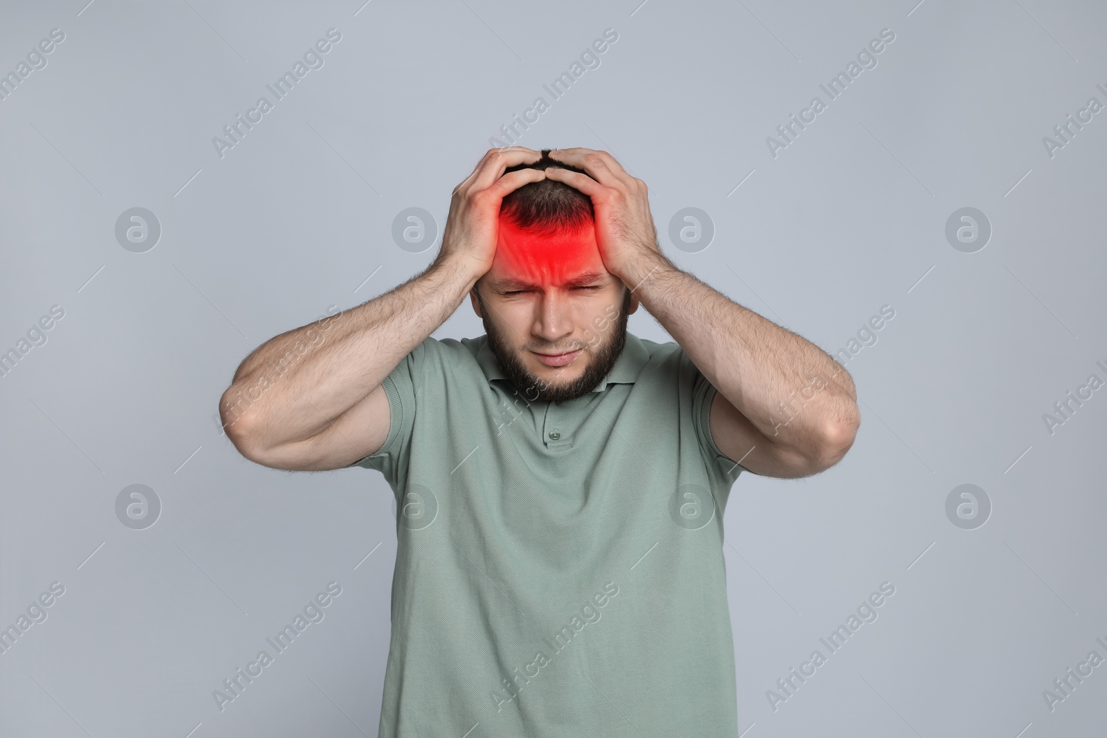 Image of Man suffering from headache on grey background