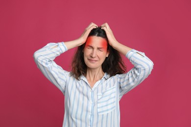 Image of Woman suffering from headache on pink background