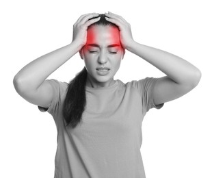 Young woman suffering from headache on light background. Black and white effect with red accent