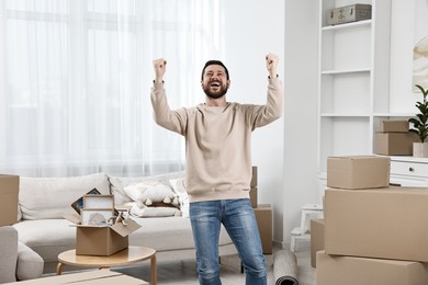 Photo of Moving day. Emotional man in his new home