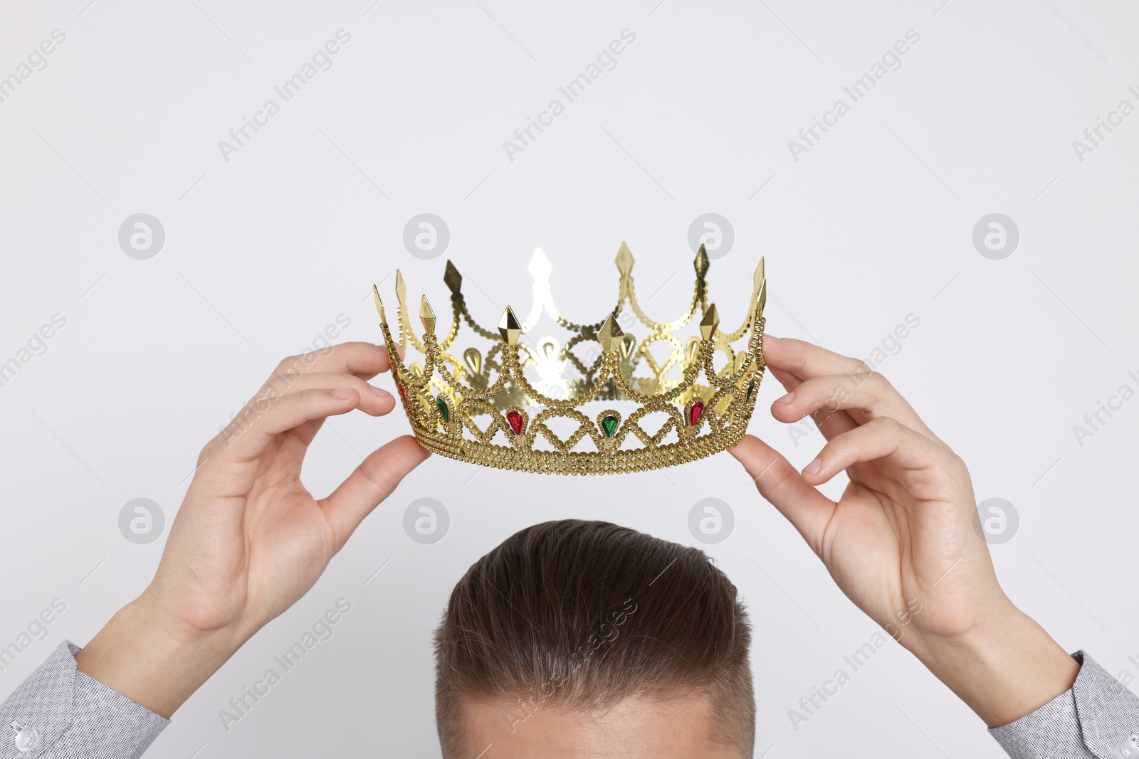 Photo of Man wearing luxury crown on white background, closeup