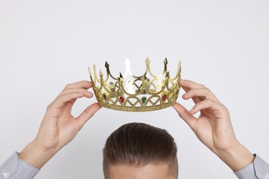 Man wearing luxury crown on white background, closeup