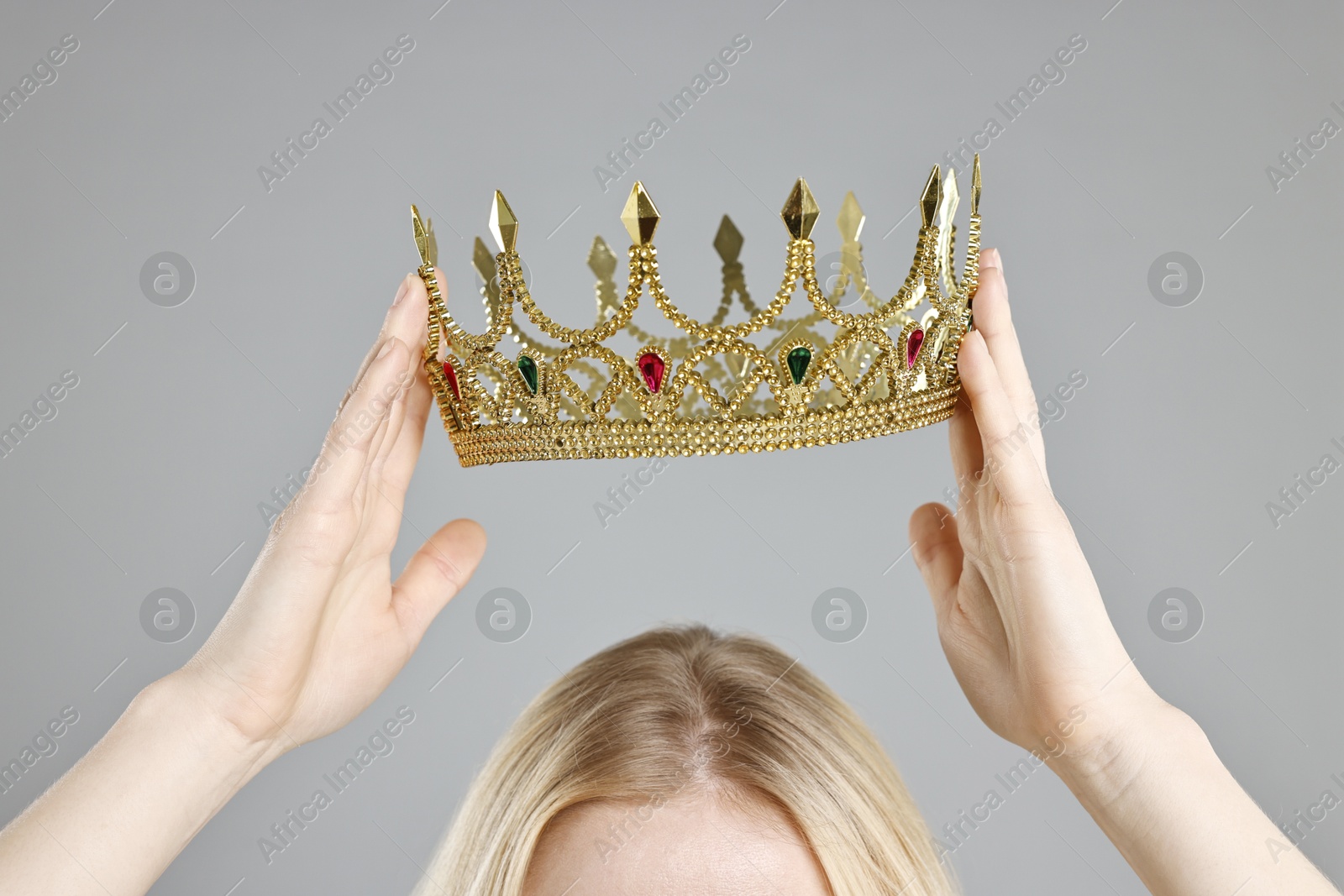 Photo of Woman wearing elegant crown on grey background, closeup