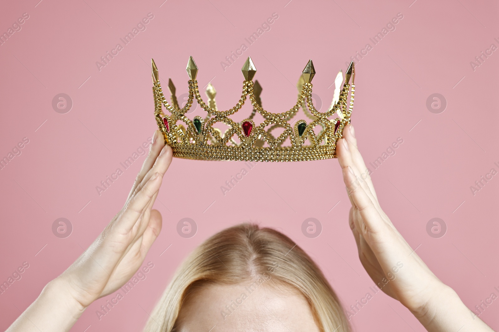 Photo of Woman wearing elegant crown on dusty pink background, closeup