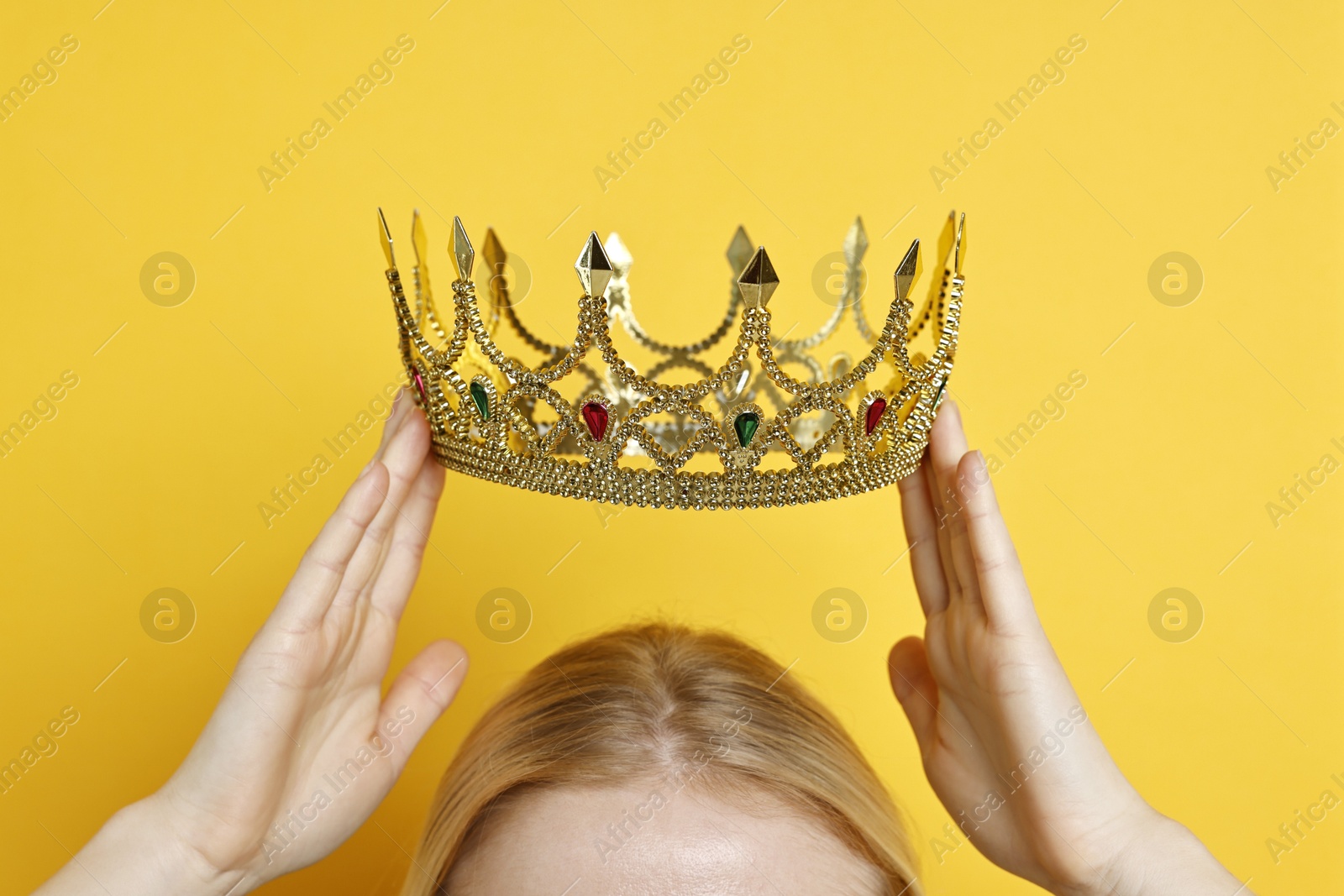 Photo of Woman wearing elegant crown on yellow background, closeup