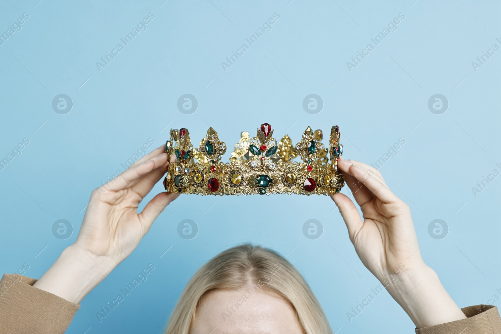 Photo of Woman wearing elegant crown on light blue background, closeup