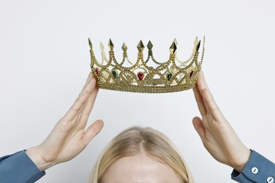 Photo of Woman wearing elegant crown on light background, closeup