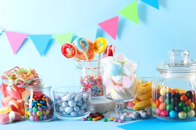 Candy bar. Many different sweets on light blue background