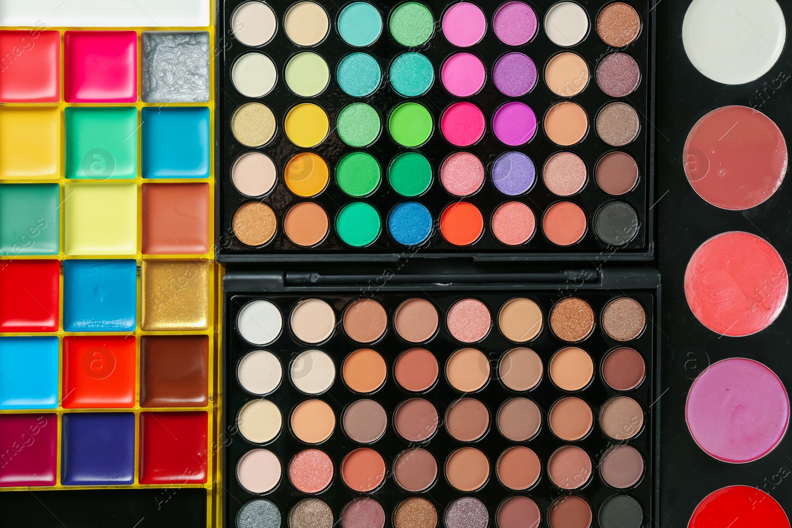 Face paints and makeup products as background, top view Photo of Face paints and makeup products as background, top view