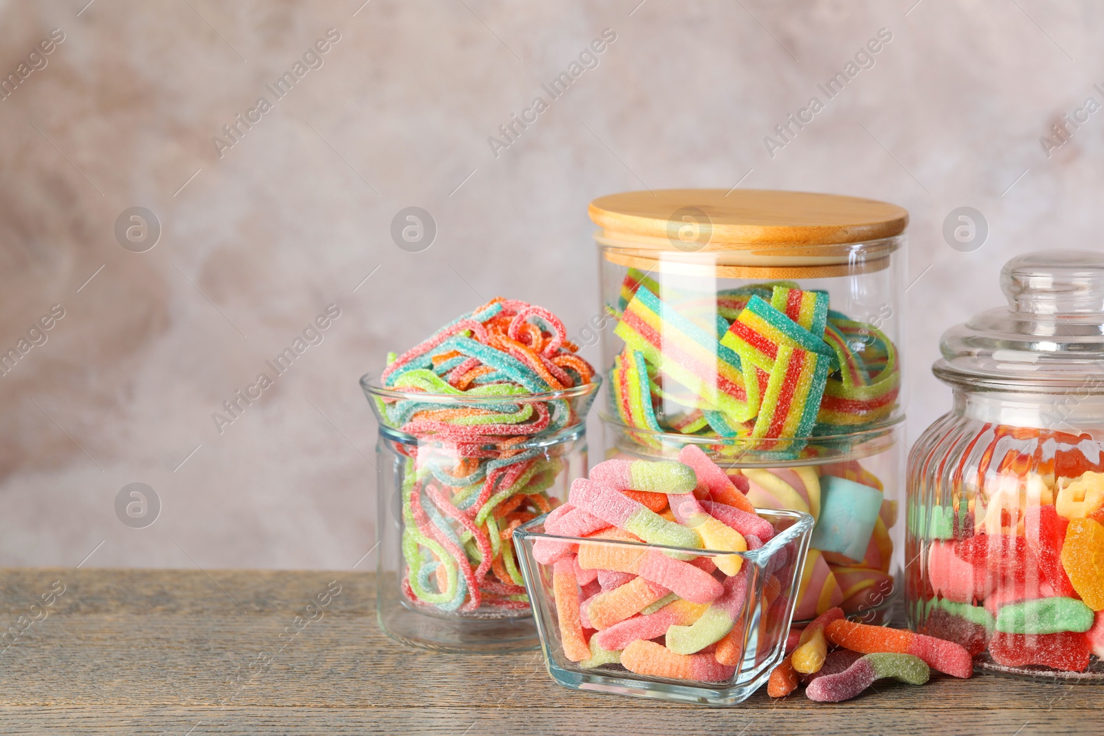 Photo of Candy bar. Many different sweets on wooden table against grey background. Space for text