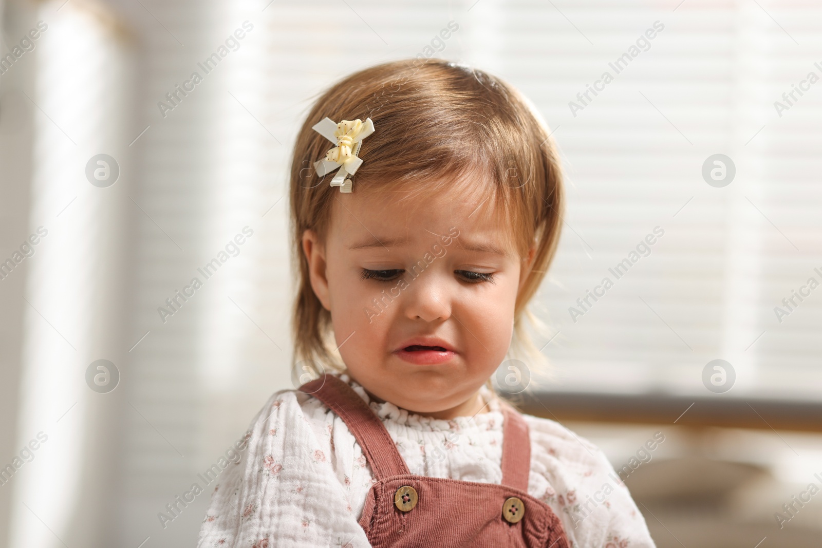 Photo of Cute little baby girl crying at home