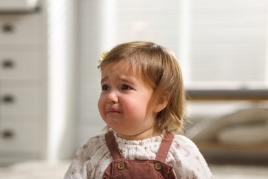 Photo of Cute little baby girl crying at home