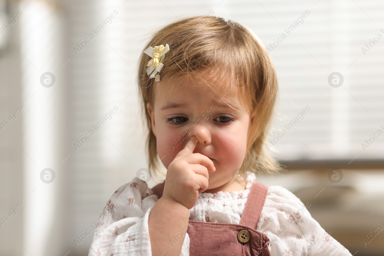 Photo of Portrait of sad baby girl at home